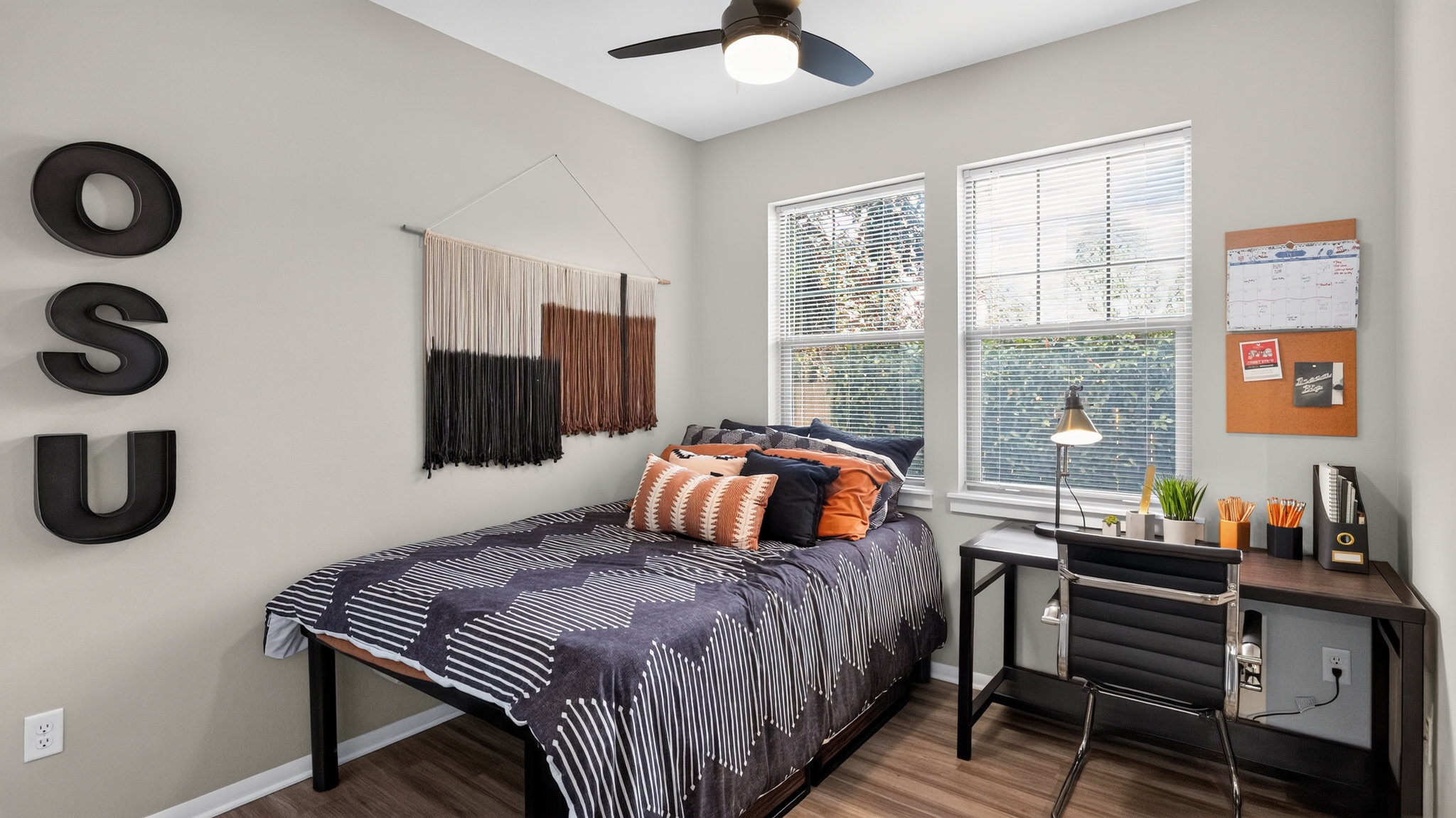 Model bedroom with a desk and ceiling fan at 7th Street Station