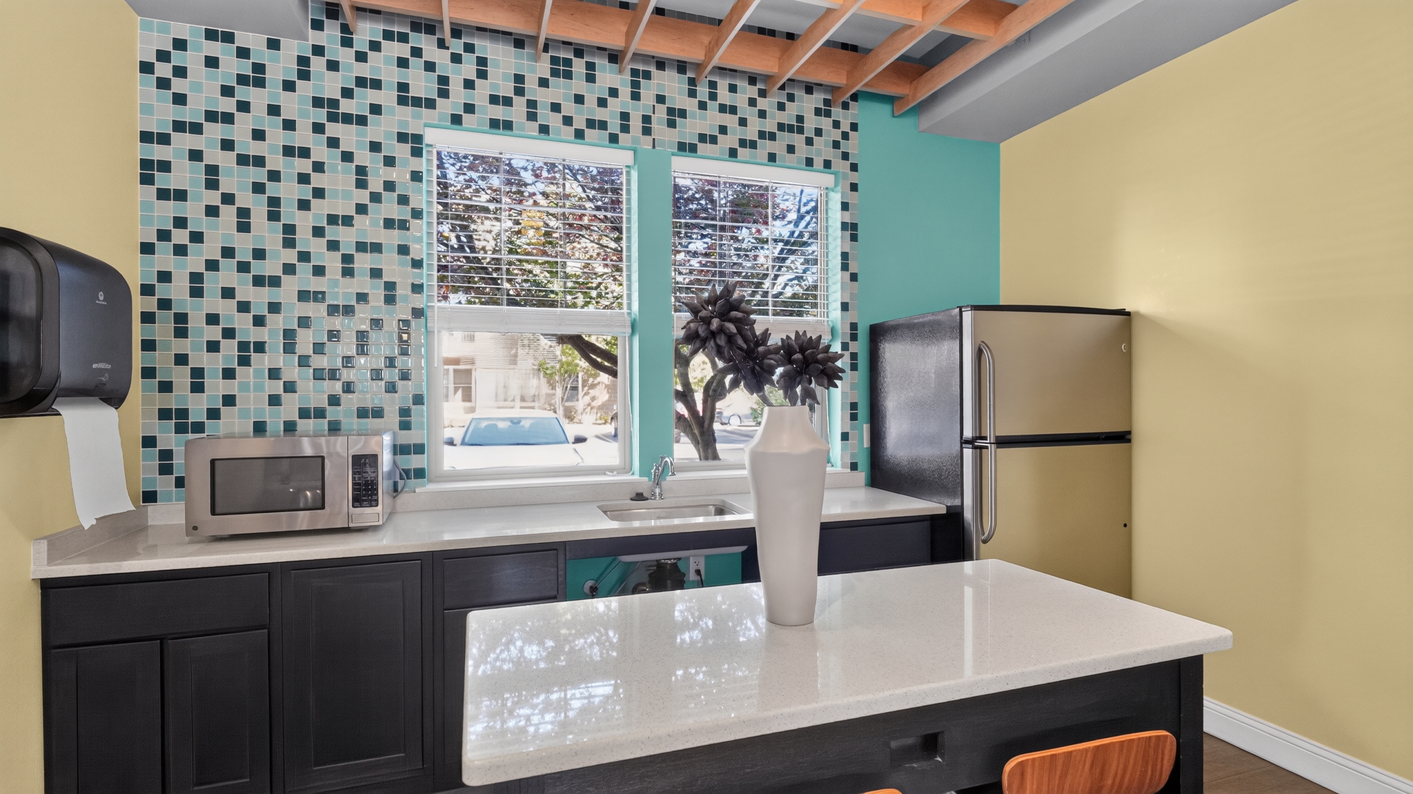 Community kitchen with island seating and full size fridge